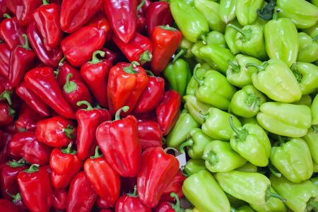 Image of a large number of fresh green and red peppers on the market.の写真素材