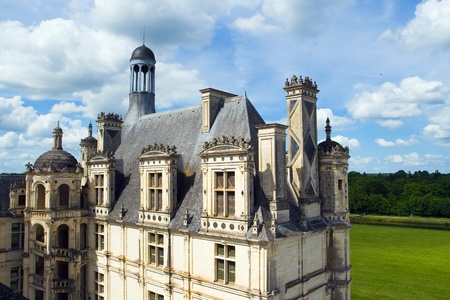 Picture the top of the castle Chambord of a series of Chateau on the Loire River. Against the background of blue sky with clouds can be seen all the details of the roof, made on the project by Leonardo de Vinci.のeditorial素材