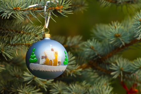 One piece of Christmas decoration of garland, on fir-tree's branch with green background having copyspaceの写真素材