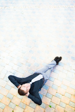 The image on top of a businessman sitting in the street, which has a success.の写真素材