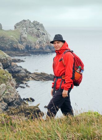 Picture of a men, resisting strong winds at the edge of the world - Finister in France.の写真素材