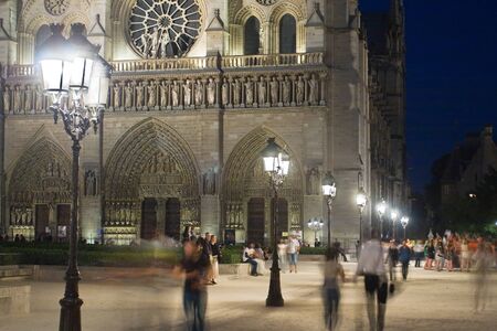 Night image of the famous cathedral of Notre-Dame in Paris against the backdrop of antique lighting lamps, France のeditorial素材