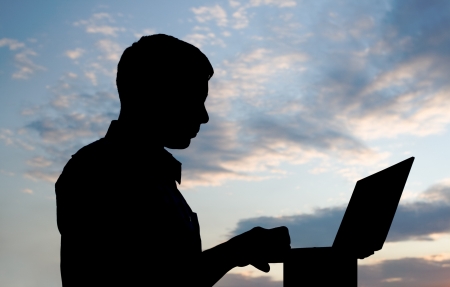 Young businessman working on laptop  Its his internet business, through wireless technologyの写真素材