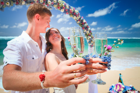 wedding couple just married with glasses of champagneの写真素材