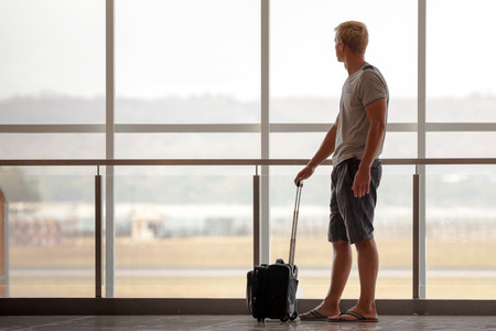 Man carries your luggage at the airport terminal of Baliの写真素材
