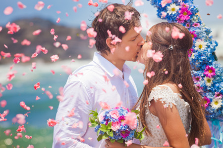 wedding couple just married with bridal bouquetの写真素材