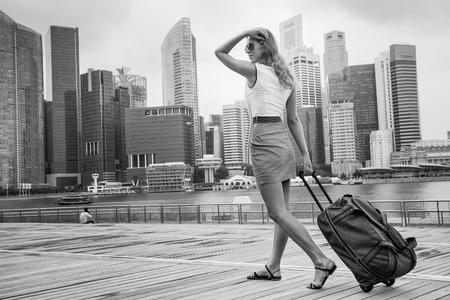 tourist adventure with suitcase in Singaporeの写真素材