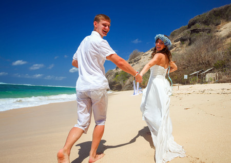 wedding jogging couple on the beachの写真素材