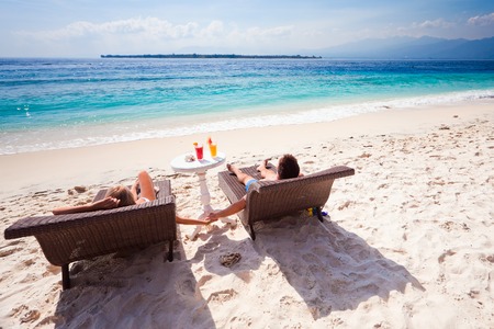 husband with his wife near blue ocean, couple just married on the beachの写真素材