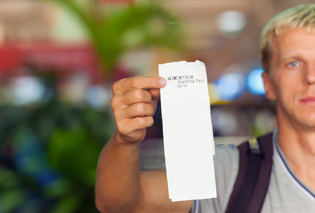 passenger holding in his hand a boarding pass templateの写真素材