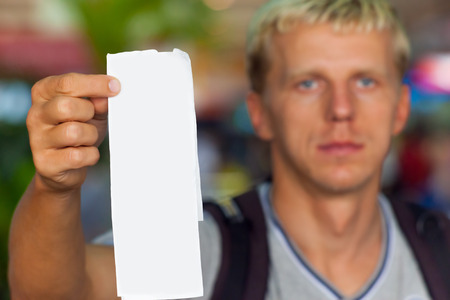 Man holding in his hand a blank for designの写真素材