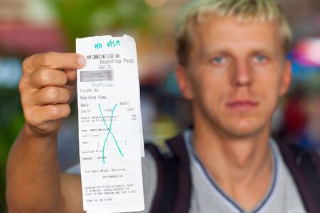 passenger holding in his hand a boarding pass templateのeditorial素材