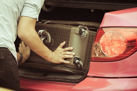 Loading luggage in a taxiの写真素材