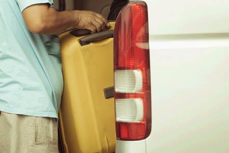 Loading luggage in a taxiの写真素材