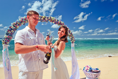 wedding couple just married with glasses of champagneの写真素材