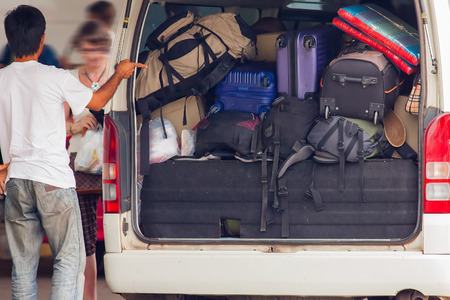 Loading many luggage in a taxiの写真素材