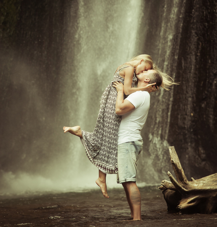 retro revival photo of couple travels to balinese waterfallの写真素材