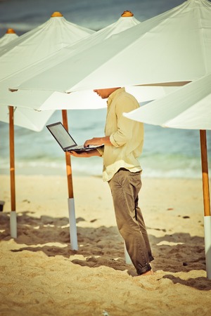concept of office man working remotely at his computerの写真素材