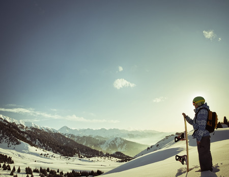 female snowboarder on the background of high snow-capped Alps in Grindelwald, Swissの写真素材