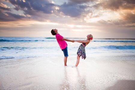 wedding couple holdings with hands near the beachの写真素材