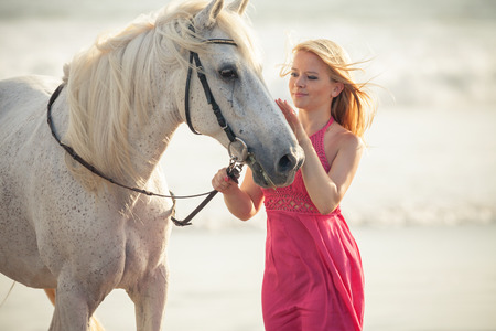 Beautiful young woman near a horseの写真素材