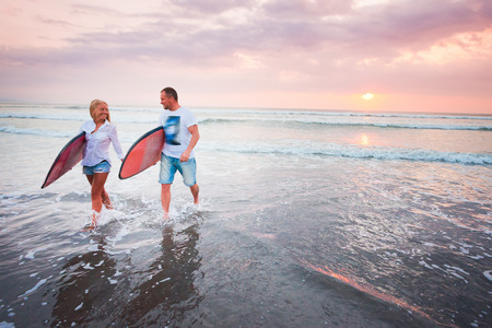 Couple of surfers walking on coast in Indonesia, Bali, Kutaの写真素材