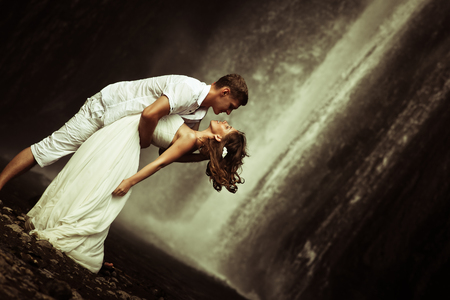 retro revival photo of couple travels to balinese waterfallの写真素材