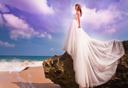 bride dressed in wedding dress, near the beach at Baliの写真素材