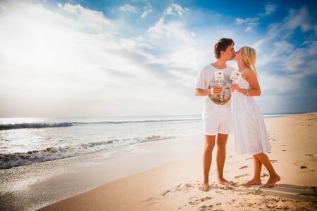 love concept at the beach with beautiful couple backgroundの写真素材