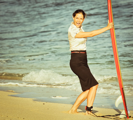 concept of office businesswoman with surf near the oceanの写真素材