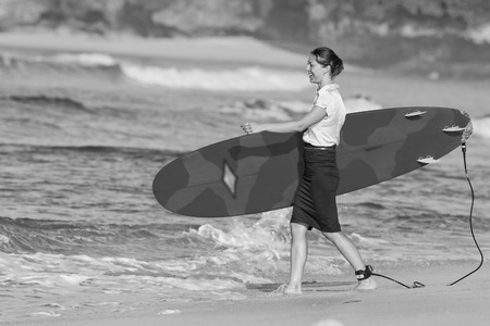 concept of office businesswoman with surf near the oceanの写真素材