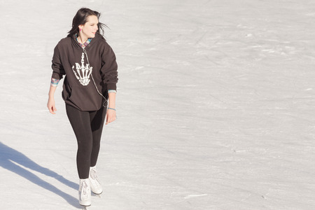 Image of young girl who are ice skating at the ice rink outdoors at Medeoの写真素材