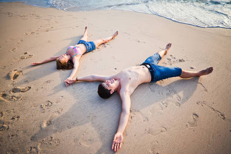 couple lying on the beach, Baliの写真素材