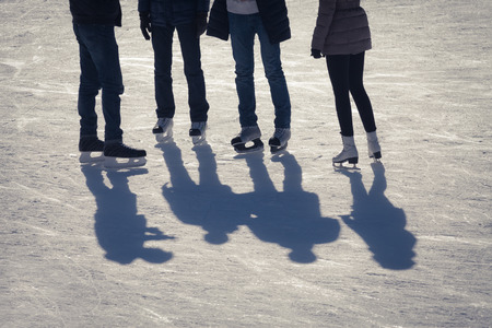 shadow background of group of teenagers on the ice holding hands at the Medeoの写真素材
