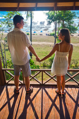 couple resting at Balinese hotel, holding handsの写真素材