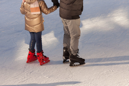 shadow background of family on the ice, they hold child's handsの写真素材