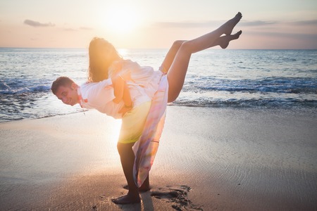 wedding couple jogging and dancing on the beachの写真素材