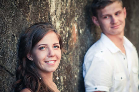 Happy couple at background of wallの写真素材