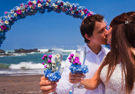 wedding couple just married with glasses of champagneの写真素材