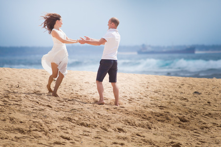 wedding couple dancing on the beachの写真素材