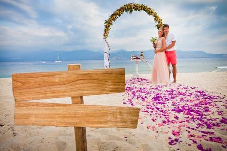 wedding couple just married near the beach at Bali with copy space for textの写真素材