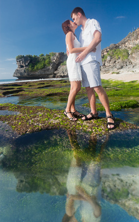 kissing couple at blue beach at Hawaii with copy space for textの写真素材