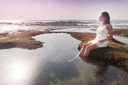 young girl resting at the water with copy space for any textの写真素材