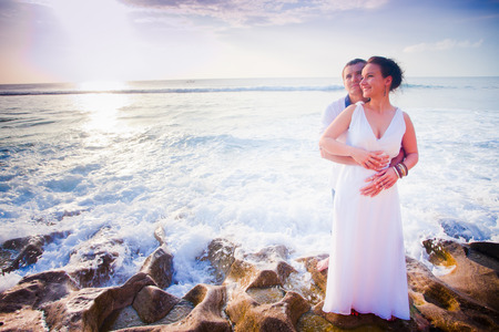 wedding couple just married at the beach, blue oceanの写真素材