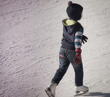 little boy in winter clothes on ice rink at Kazakhstan, Almatyの写真素材
