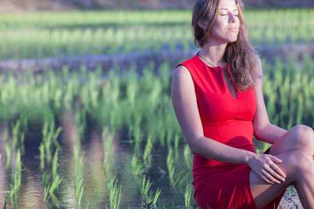 girl travels in Asia, she sits on the rice terracesの写真素材