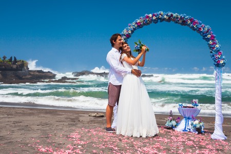 wedding couple just married near the beach at Baliの写真素材
