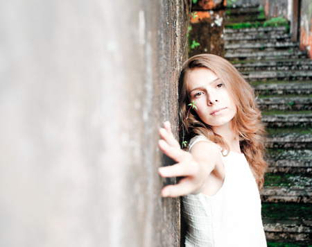 young girl posing against background wall at hotel, with copy space for any textの写真素材