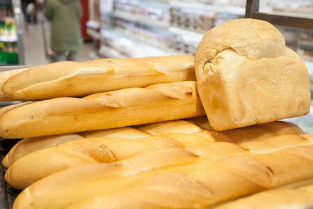 background of fresh bread - French baguette at supermarketの写真素材