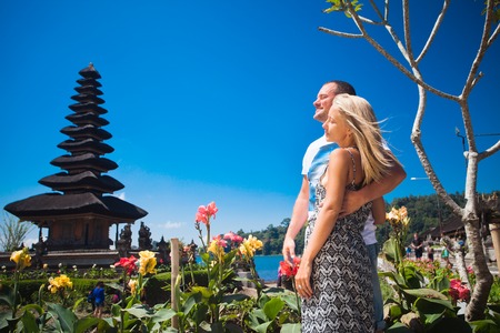 Honeymoon couple near the Balinese temple at beratan lake, Baliの写真素材